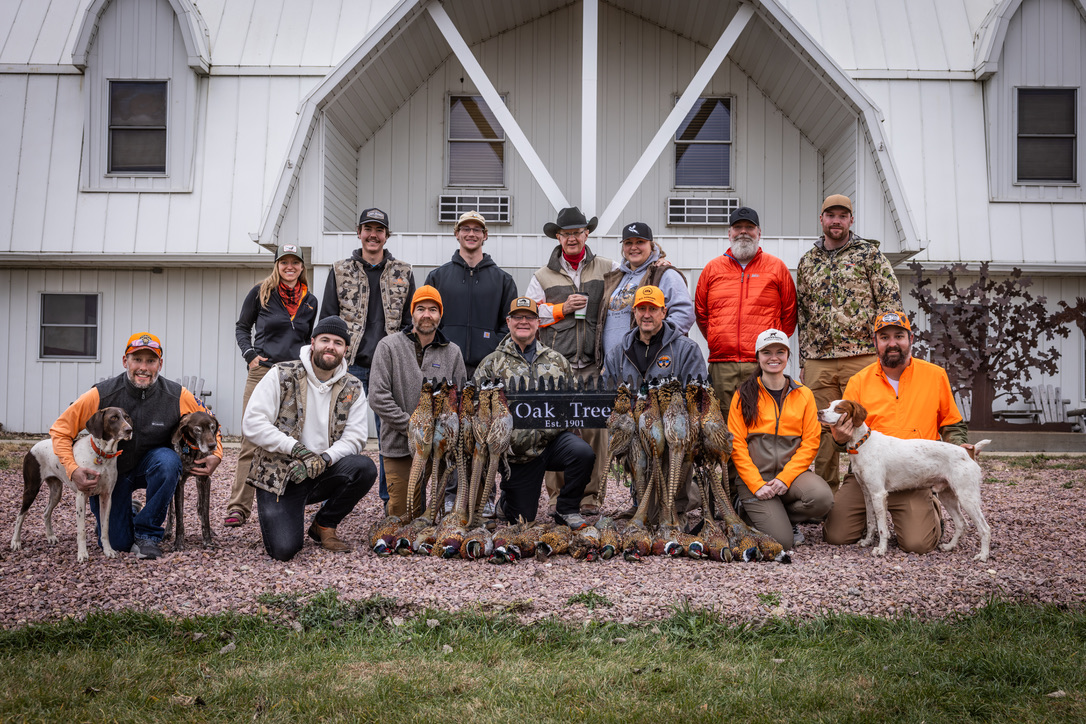 The full party gathered in front of the lodge with the day's birds