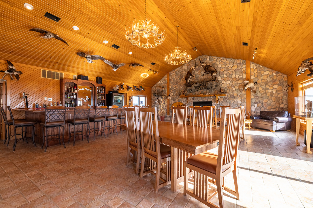 The great room — timber beams, leather, and firelight
