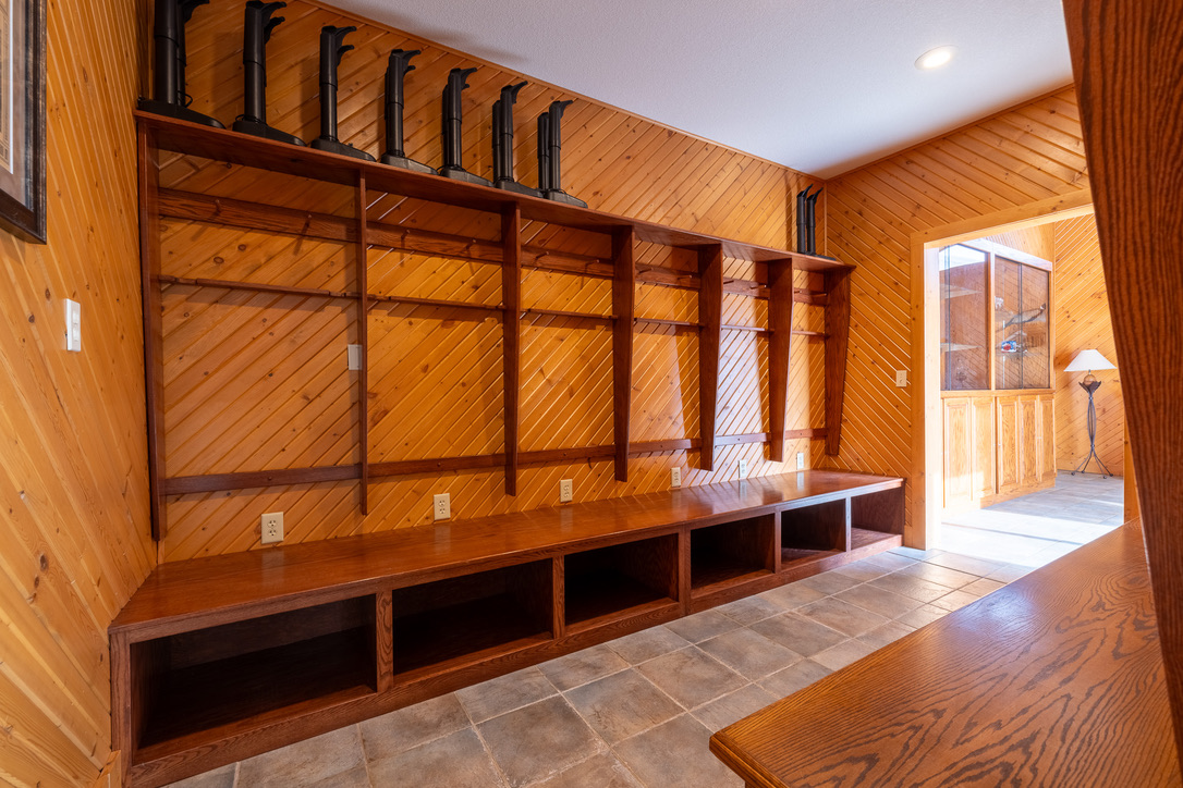 Custom gun room with racks and diagonal pine walls