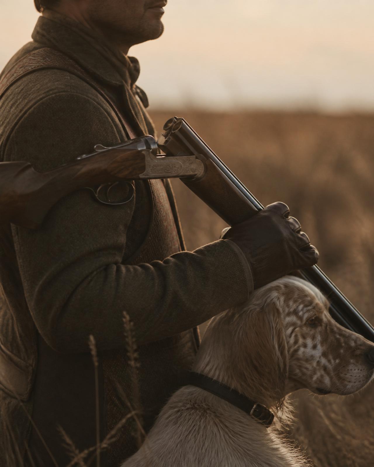 Hunter and pointer at daybreak on the South Dakota prairie